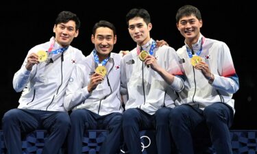 Korea poses with their gold medals in the men's sabre team event