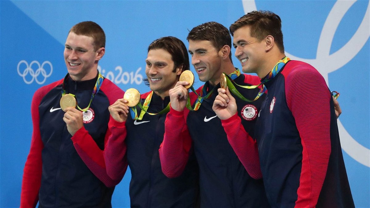 Members of the U.S. men's 4x100 medley relay team hold up their gold medals