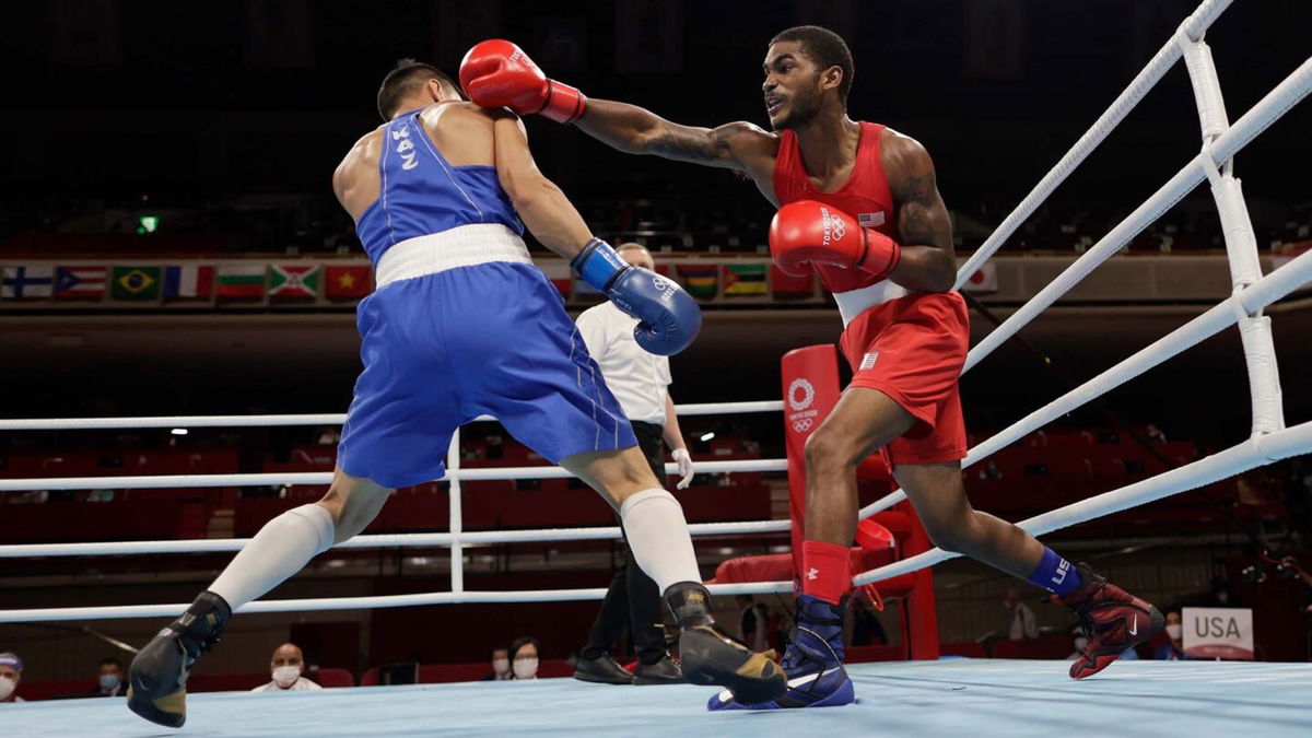 Low angle of Tiger Johnson's fist connecting with Ablaikhan Zhussupov's shoulder