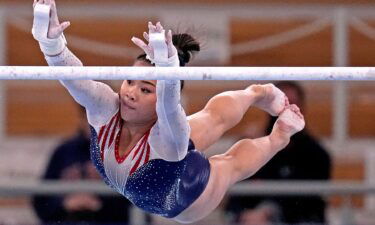 Suni Lee competes on the uneven bars