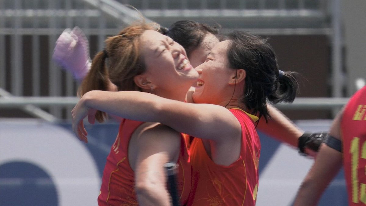 Members of the China Field Hockey Team celebrate after their win
