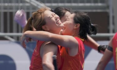 Members of the China Field Hockey Team celebrate after their win
