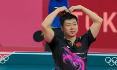 Ma Long gives a hand heart after his gold medal win