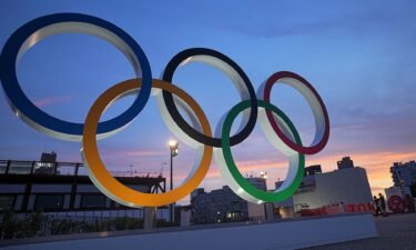 Olympic rings stand in the evening twilight.
