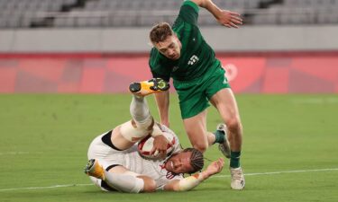 Stephen Tomasin grimaces as he scores against Ireland