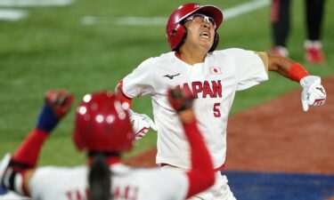 Japan third baseman Yu Yamamoto (5) reacts after scoring against the United States of America on an RBI single hit by designated player Yamato Fujita (not pictured) during the fifth inning in the gold medal game of the Tokyo 2020 Olympic Summer Games