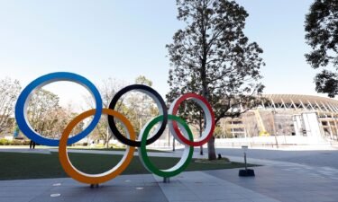 The Olympic rings appear next to Tokyo National Stadium