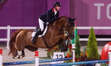 Ben Maher and his horse go over a blue jump