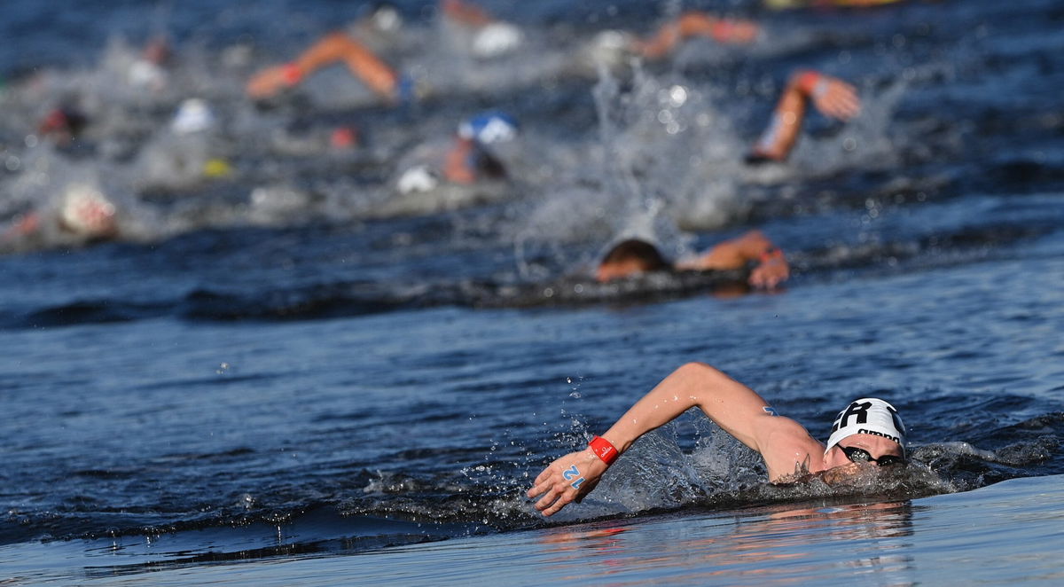 Germany's Florian Wellbrock competes to win and take gold in the men's 10km marathon swimming event during the Tokyo 2020 Olympic Games.