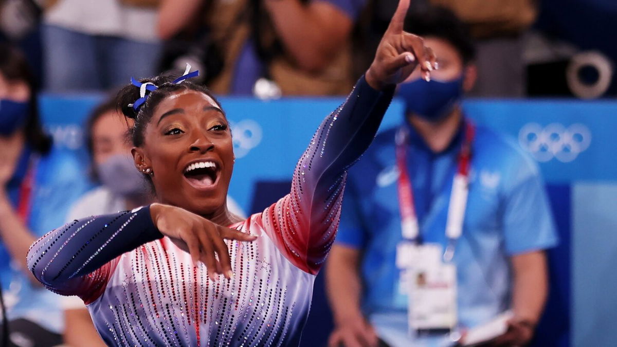 Simone Biles points to the crowd