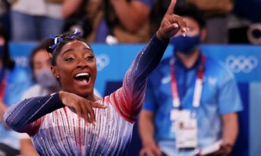 Simone Biles points to the crowd