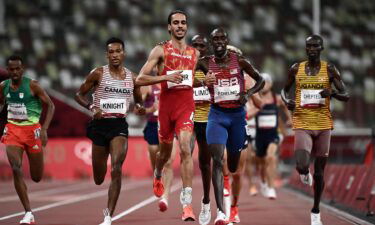 Winner Spain's Mohamed Katir (L) speaks with second-placed USA's Paul Chelimo after competing in the men's 5000m heats during the Tokyo 2020 Olympic Games