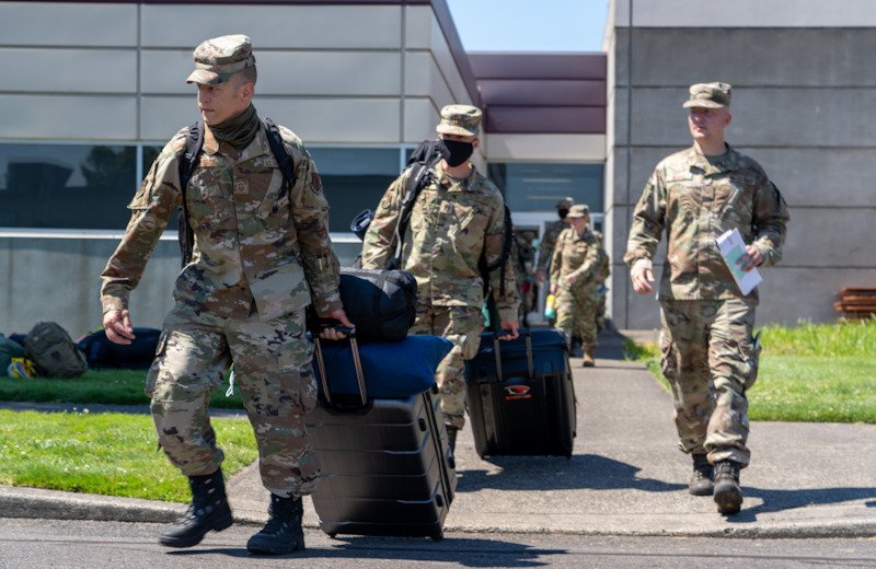 Oregon Air National Guard Senior Master Sgt. Joshua Pousson, 142nd Maintenance Group, leads a group of airmen departing Portland Air National Guard Base in support of OPLAN Smokey