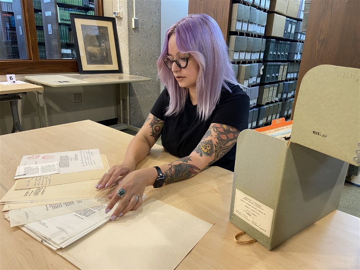 <i>ERIN GRETZINGER/STATE JOURNAL</i><br/>Kacie Lucchini Butcher pages through documents detailing a 20-year-long housing discrimination fight on campus as part of a project detailing the history of discrimination on campus.
