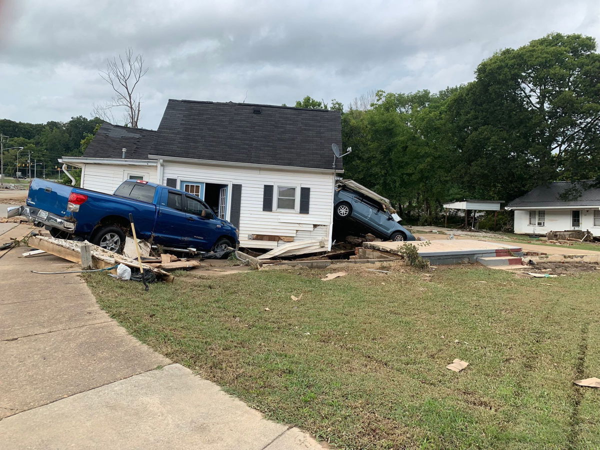 <i>Steve Smith</i><br/>Vehicles are shown crashing through a house after flooding damage in Tennessee on August 21.