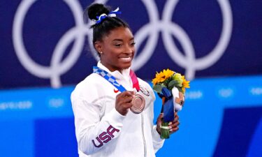 Simone Biles poses with bronze medal