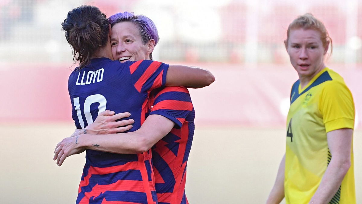 Megan Rapinoe embraces Carli Lloyd after scoring in the bronze medal match