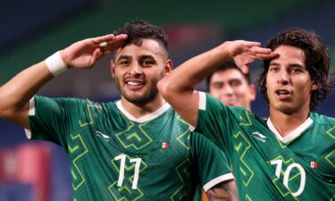 Alexis Vega and Diego Lainez of Mexico salute after Mexico increased its lead over Japan