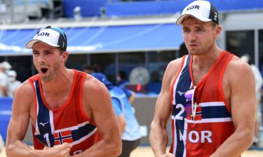 Norway's Anders Mol and Christian Sorum flex their biceps in celebration