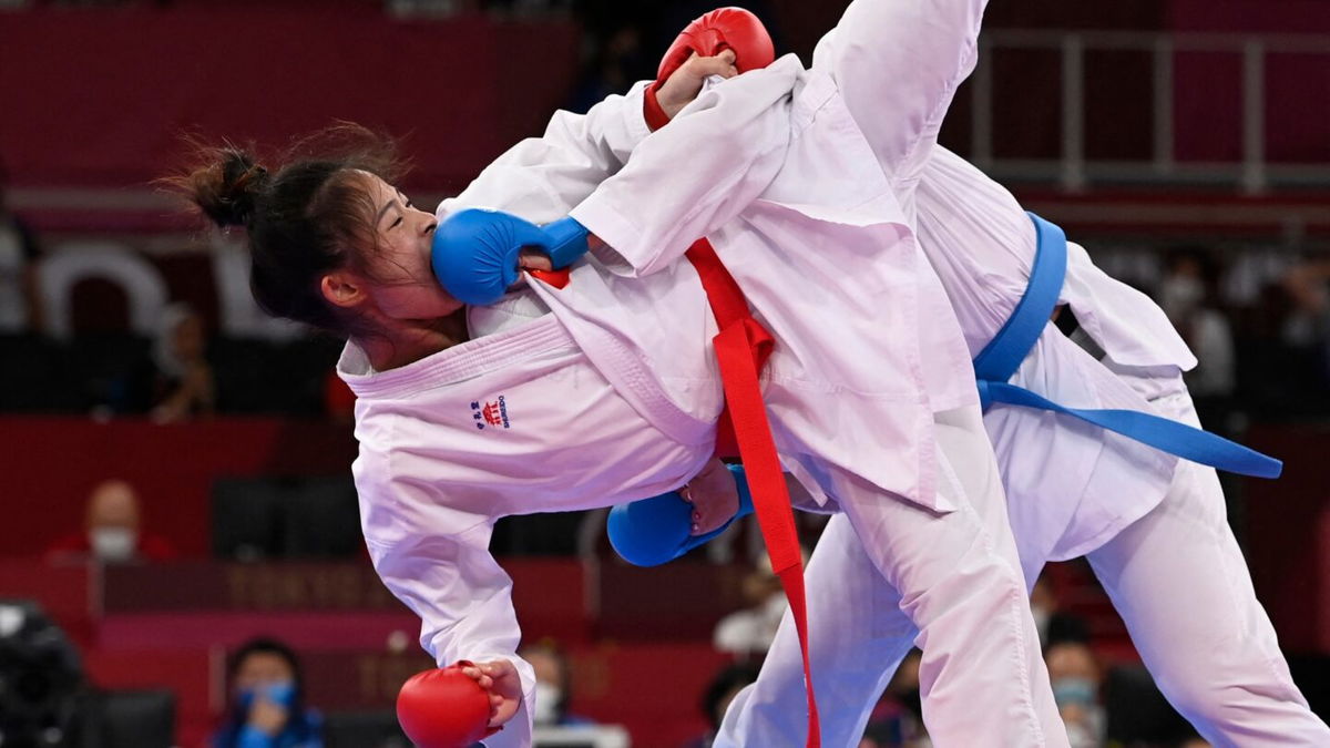 China's Gong Li takes a kick to the face from Switzerland's Elena Quirici