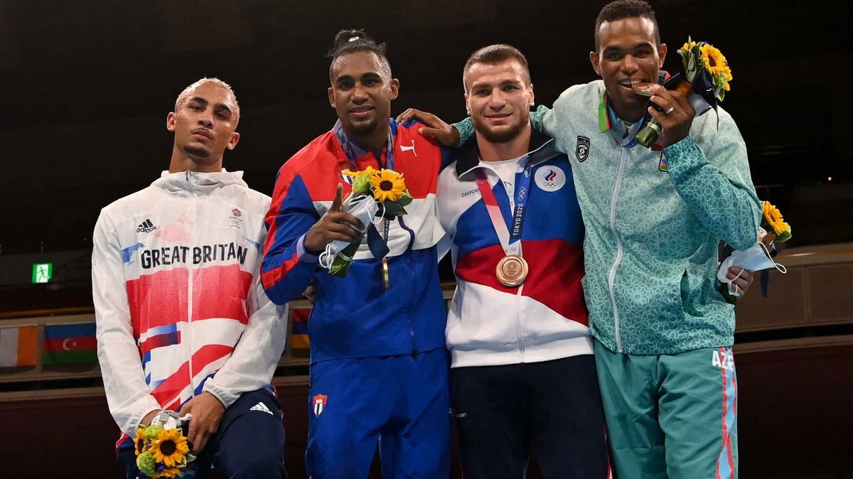 A sullen Benjamin Whittaker refuses to wear his silver medal next to gold medalist Arlen Lopez of Cuba and bronze medalists Imam Khataev of the ROC and Loren Berto Alfonso Dominguez of Azerbaijan.