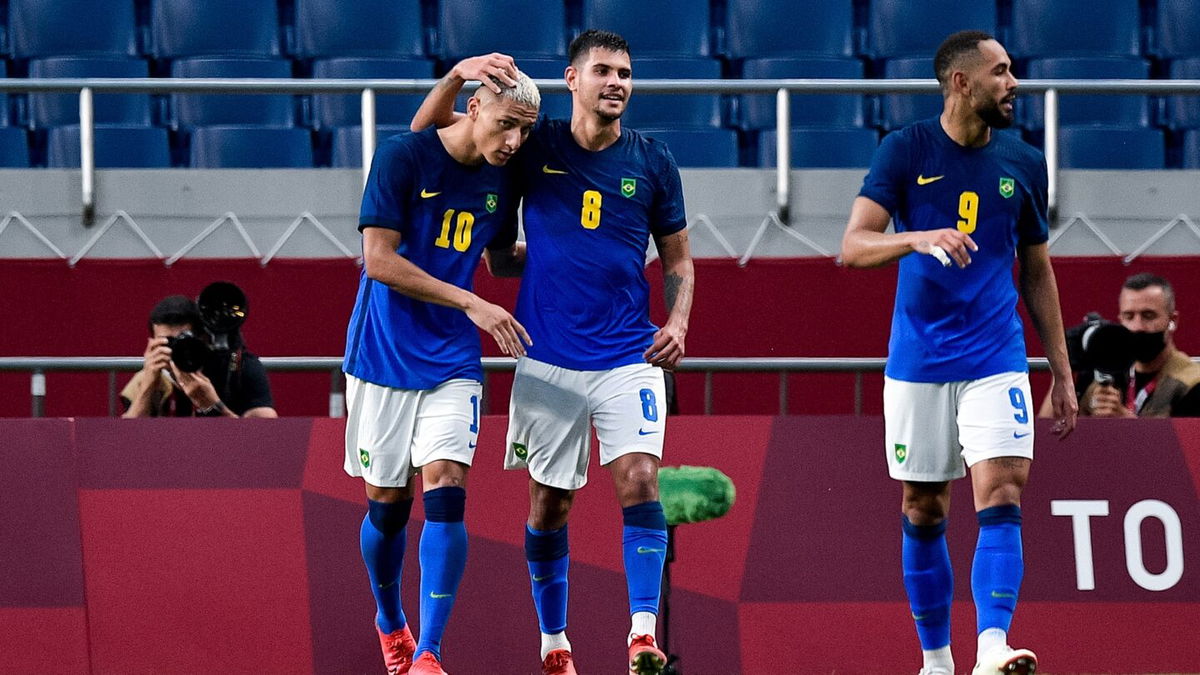 Neymar and Richarlison celebrate in a match against Saudi Arabia.