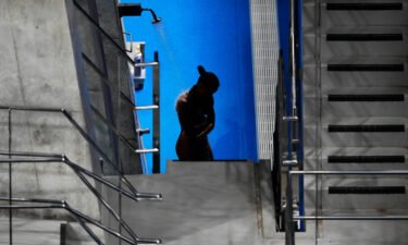 Jennifer Abel of Canada rinses off in between rounds of the women's diving 3-meter springboard preliminary event at the Tokyo Olympics on July 30