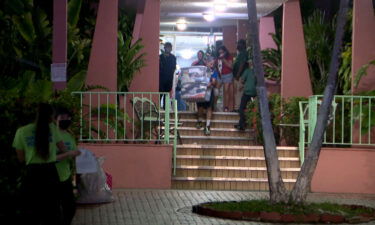 Residents evacuate a building in Miami's Flagami neighborhood.