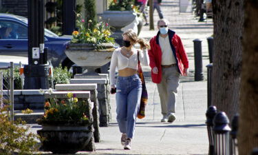 Oregon will soon require people to wear masks outdoors in public settings where physical distancing isn't possible. People wearing masks here walk in downtown Lake Oswego