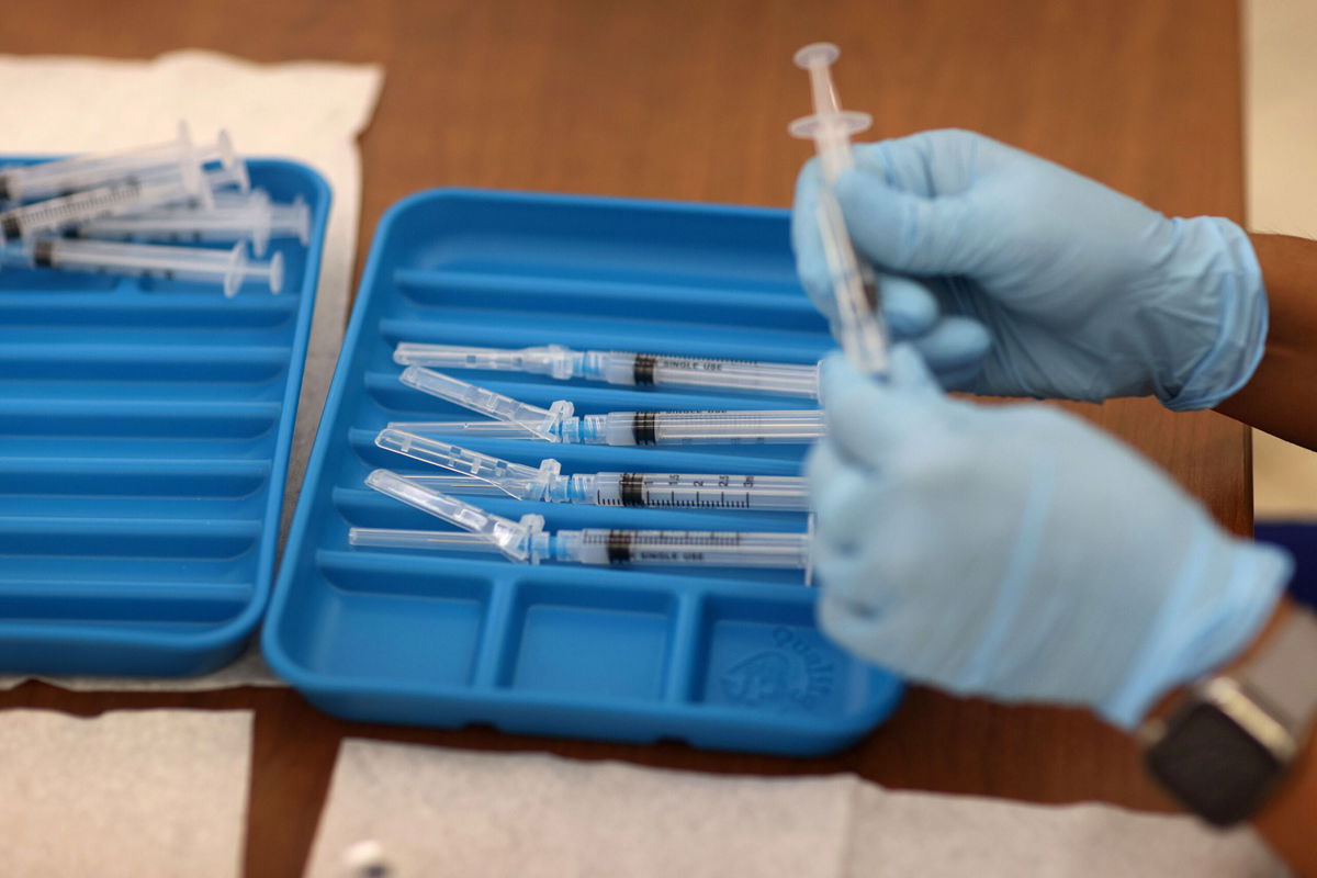 <i>Joe Raedle/Getty Images</i><br/>A healthcare worker prepares Moderna COVID-19 vaccines at a clinic on May 20