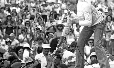 Tom T. Hall leans to the edge of the stage at the Jamboree in the Hills to meet the people near St. Clairsville