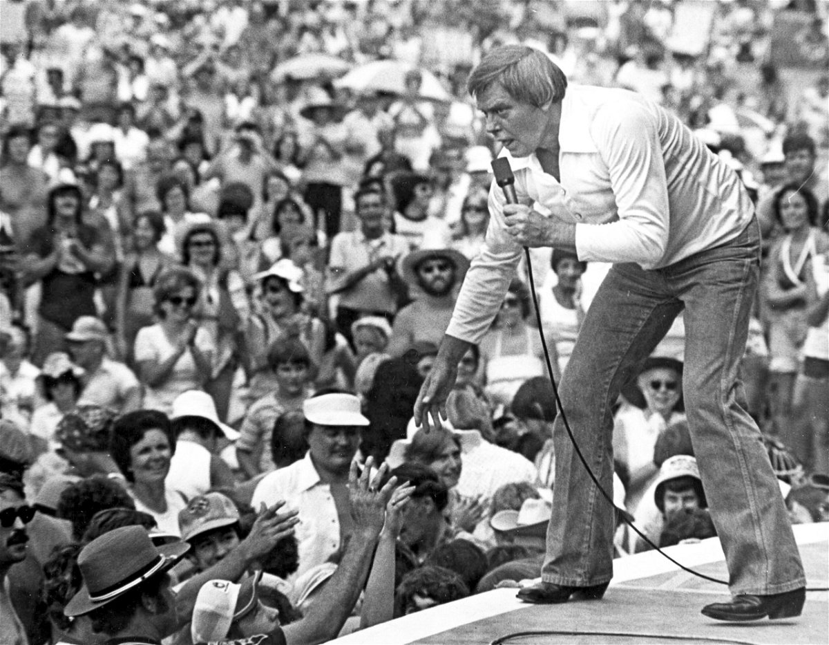 <i>AP</i><br/>Tom T. Hall leans to the edge of the stage at the Jamboree in the Hills to meet the people near St. Clairsville