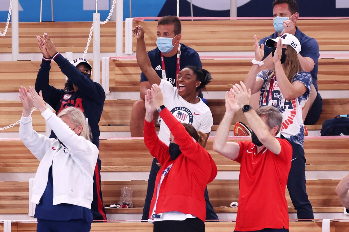 <i>Jamie Squire/Getty Images</i><br/>Simone Biles cheers with teammates Jordan Chiles (left) and Grace McCallum (right) from the stands during the women's vault final.