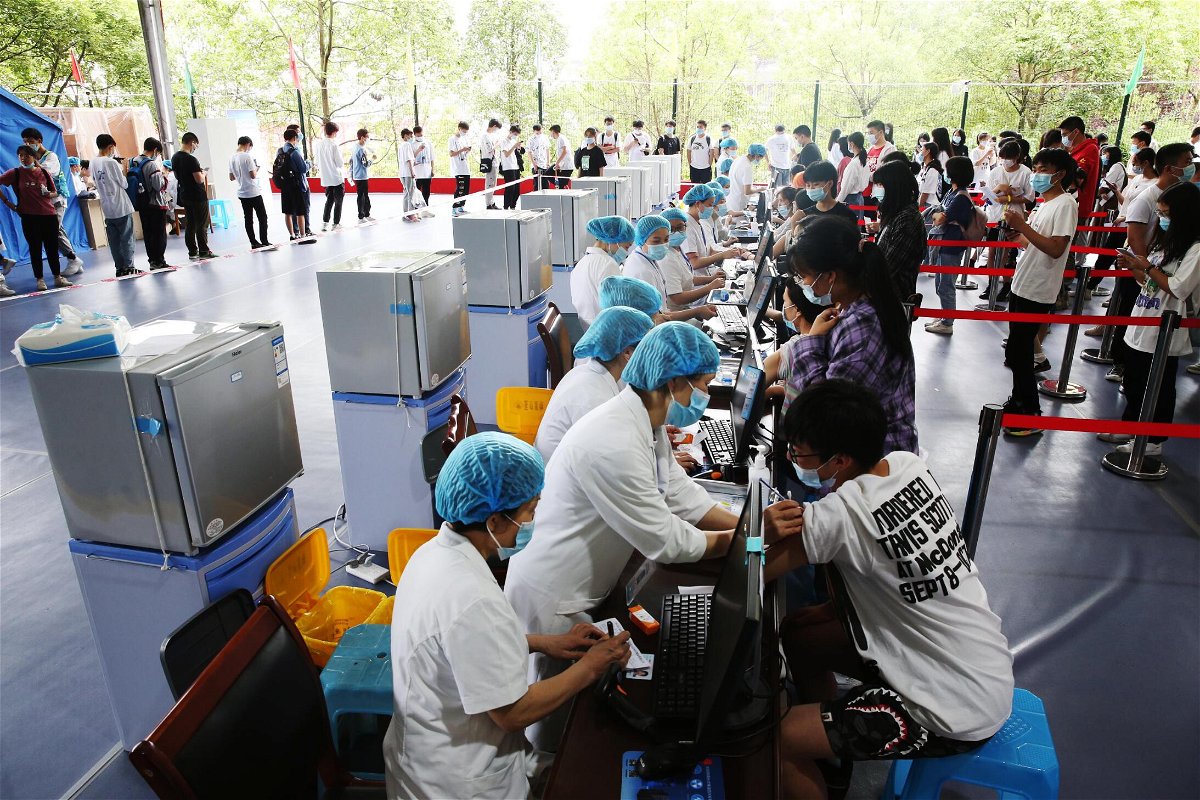 <i>Costfoto/Barcroft Media/Getty Images</i><br/>Doctors give Covid-19 vaccine to high school seniors at a temporary vaccination site in Chongqing