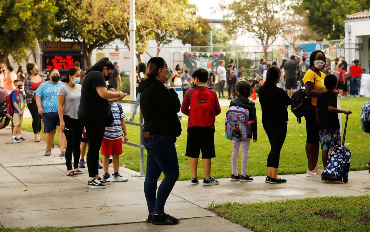 <i>Al Seib/Los Angeles Times/Getty Images</i><br/>Filtered or fresh air is another way to help protect students from breathing in the virus. Parents and students here form lines outside Lankershim Elementary School in North Hollywood on August 17.
