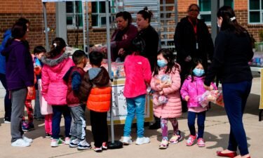 Children pick up lunch at Kenmore Middle School in Arlington