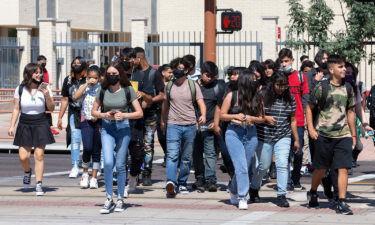 Teacher Douglas Hester sues the Phoenix Union High School District and its governing board over their mask mandate. Students here leave Central High School in Phoenix on August 2.