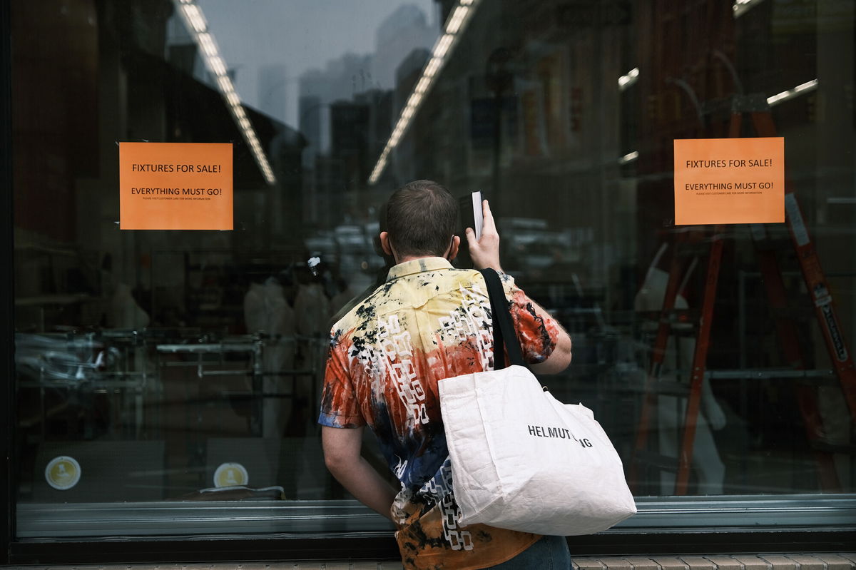 <i>Spencer Platt/Getty Images</i><br/>A person pauses in front of a closed Kmart store at Astor Place in New York's East Village on July 13