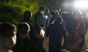 Migrant families are processed by United States Border Patrol after crossing the Rio Grande into the United States in Roma