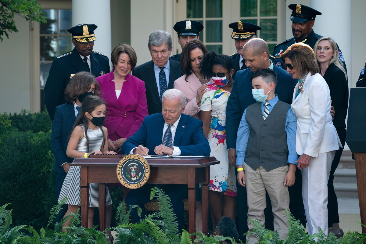 <i>Evan Vucci/AP</i><br/>President Joe Biden signs a bill that awards Congressional gold medals to law enforcement officers that protected members of Congress at the Capitol during the January 6 riots.