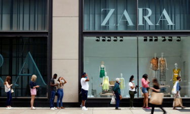 The US economy grew slightly more in the second quarter. Shoppers are seen outside a Chicago downtown retail store