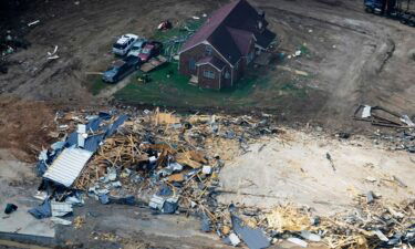 Search efforts have been suspended in Tennessee following deadly flooding Saturday. Damaged homes and cars are seen here Wednesday in Waverly