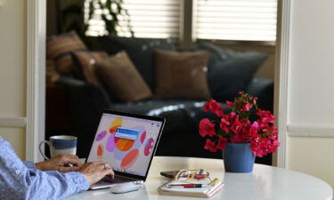 Synchrony CEO: We'll never go back to the old way of working. This illustration photo shows a person working on their laptop from a home office in Los Angeles on August 14.