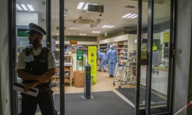 A man has been arrested on suspicion of contaminating food at three London stores. Forensic investigators are pictured inside one of the affected supermarkets.
