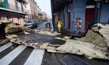 A section of roof that was blown off of a building in the French Quarter by Hurricane Ida winds blocks an intersection on August 30