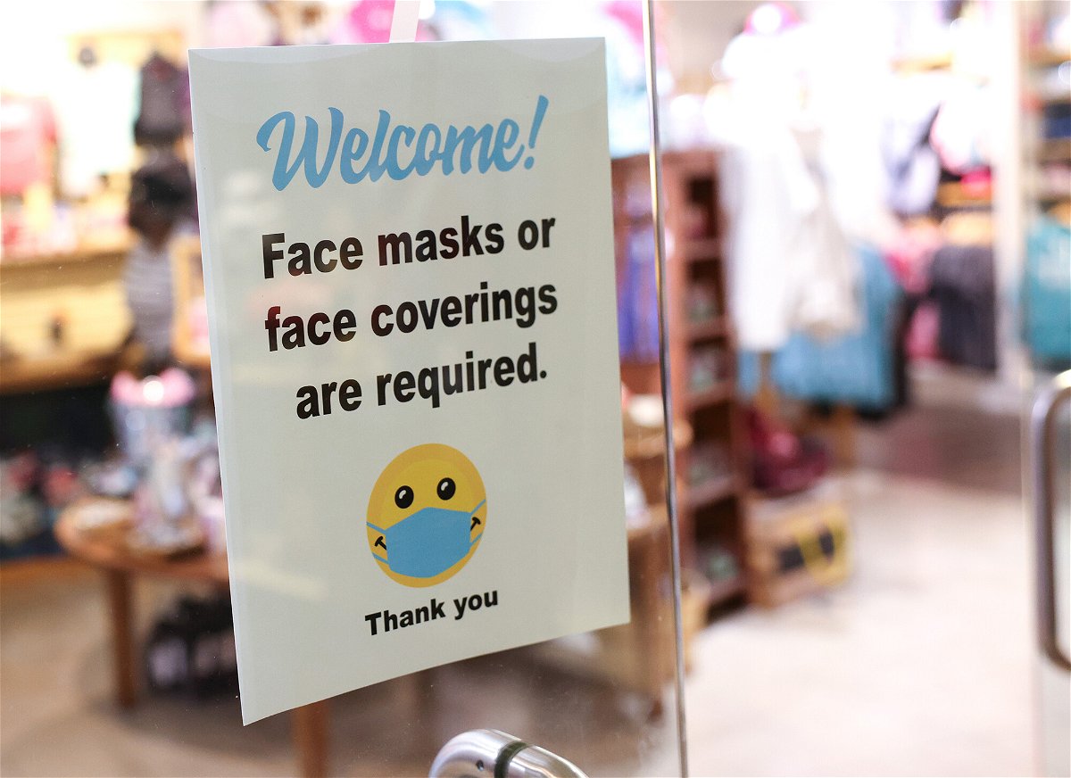 <i>Kevin Dietsch/Getty Images</i><br/>A sign requiring mask use is seen outside of a store in Union Station on July 30