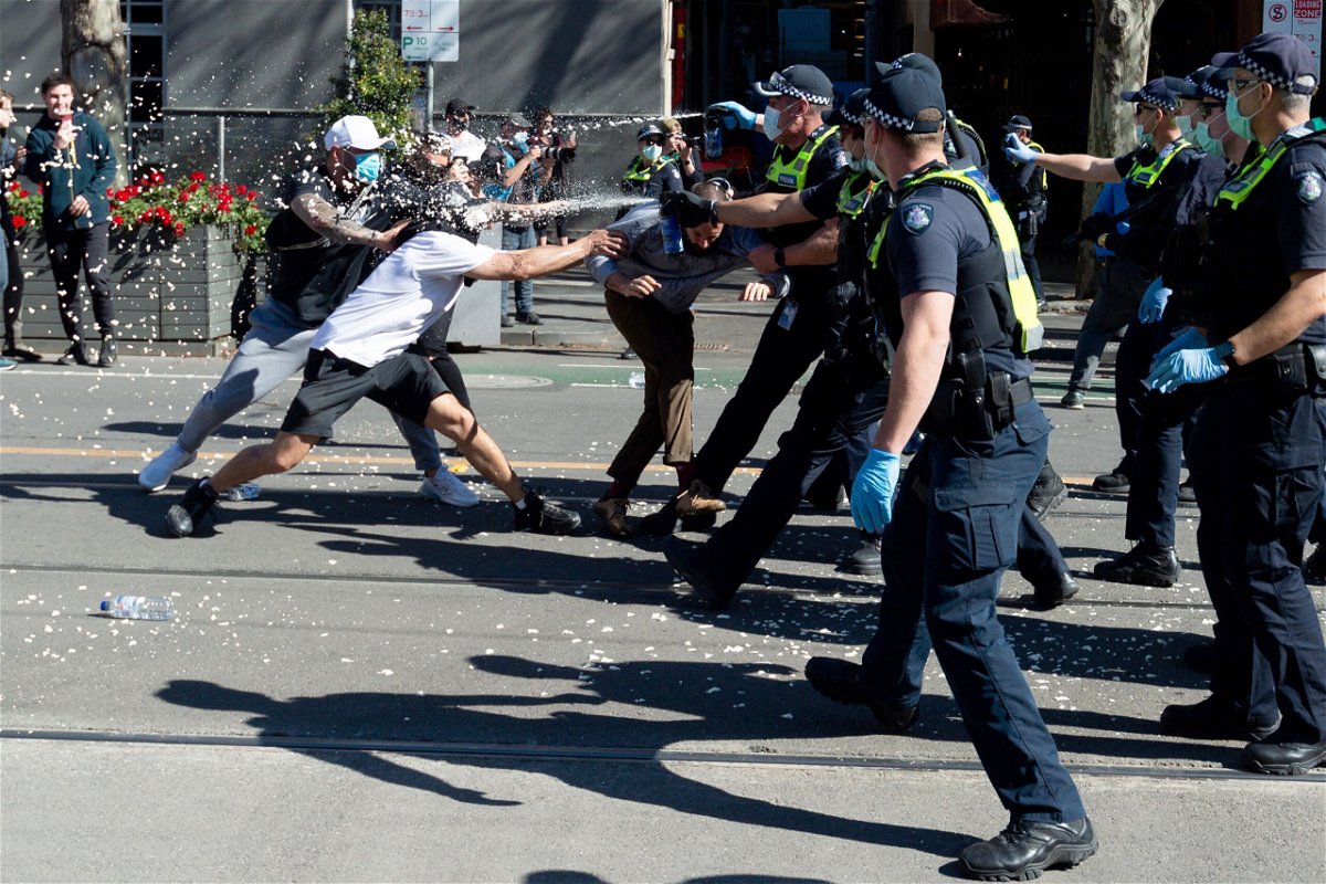 <i>Mikko Robles/Speed Media/Shutterstock</i><br/>Police deploy capsicum spray on protesters in Melbourne.