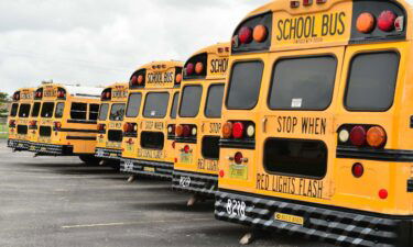 A fleet of Broward County School buses are parked in a lot on July 21