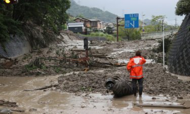 A landslide triggered by a torrential rain covers a road in Otsu
