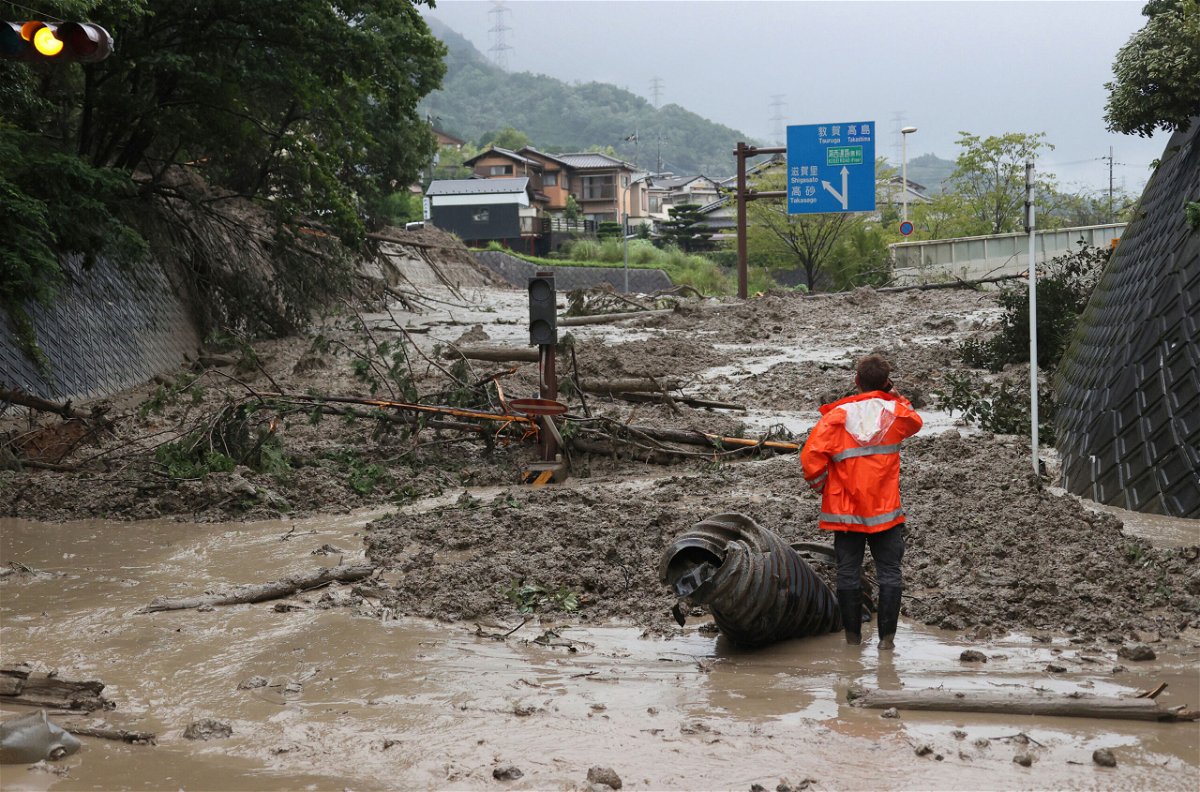 <i>Ken Satomi/AP</i><br/>A landslide triggered by a torrential rain covers a road in Otsu